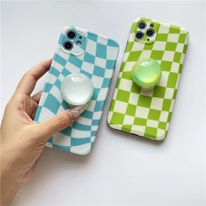 Detail of expandable checkerboard phone grip and glossy protective case on device