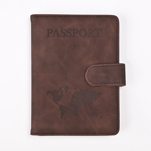 Detailed close-up of brown PU leather passport holder with embossed world map and airplane