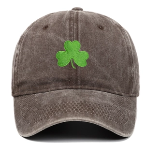 Detailed view of green shamrock embroidery on vintage washed canvas baseball cap