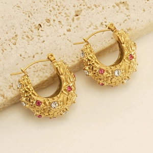 Macro detail of chunky 18K gold plated hoop earrings with pink and white crystal stones