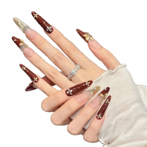 Red and gold Christmas stiletto press-on nails with 3D floral and pearl accents