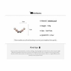 Detail view of pink imitation pearl earrings set with silver needles and 1cm dimensions