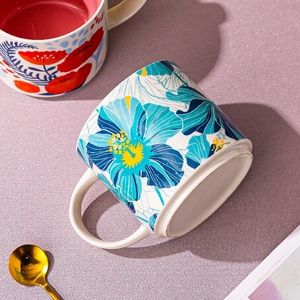 Nordic floral ceramic mug set with vibrant hibiscus patterns and golden spoon