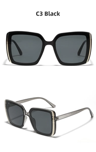 Detail view of square black sunglasses with metallic accents and transparent grey temples