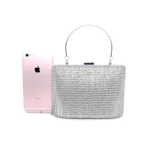 Silver rectangular evening clutch with rhinestones compared to a phone for scale