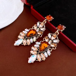 Vintage gold drop earrings with amber and champagne crystals on elegant brown silk