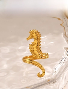 Detailed view of seahorse ring with golden mesh texture on a water ripple base