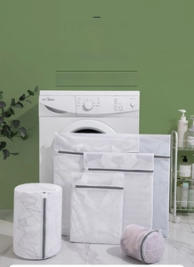 Various sizes of fine mesh laundry bags in a laundry room setting for clothing protection