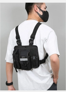 Rear view of model wearing black tactical vest chest bag with multiple functional pockets