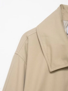 Detail of khaki jacket collar and shoulder stitching showing twill fabric texture