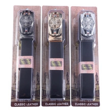 Three leather belts with dark gray, gold and silver metal buckles in classic packaging