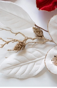 Macro detail of Christmas floral branch with velvet petals and golden glitter accents