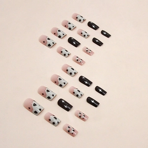 Chocolate donut style press-on nails with pink panda spots and black star patterns