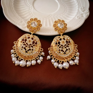 Vintage palace style gold earrings with sparkling rhinestones and white pearls pendant