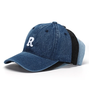 Detail of embroidered R letter on vintage washed denim baseball caps in multiple colors