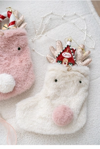 Detailed view of pink and white plush Christmas stockings with reindeer antlers