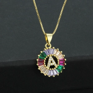 Gold letter A necklace with colorful zircon stones on a black velvet background