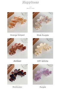 Detail view of large acetate flower petal hair claws in six diverse color patterns