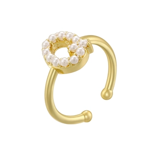 Detail of a gold open ring with a circular pearl cluster top on a white background