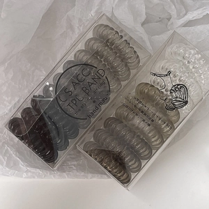 9-piece set of spiral telephone wire hair ties in brown and clear TPU with storage boxes