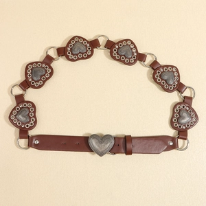 Detail of brown vintage western belt featuring metal heart links and a classic pin buckle