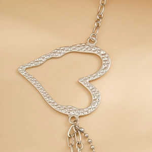Silver hollow heart metal waist chain with textured frame and thin link body chain style