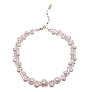 Minimalist pearl choker necklace featuring woven lace pattern and gold lobster clasp