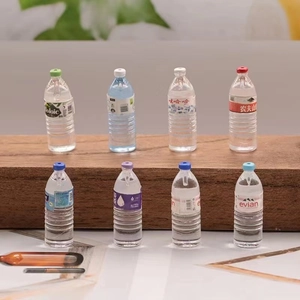 Detail macro shot of miniature resin water bottles in various colors for DIY crafts