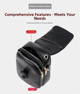 Detail view of black lychee grain leather crossbody bag with multiple zipper compartments