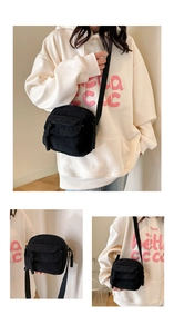 Detail view of black corduroy square bag with woven rope zipper and textured fabric