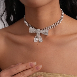Sparkling silver bow choker necklace with full diamonds worn by model on neck