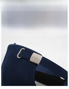 Detailed close-up of the adjustable silver metal buckle on a navy blue baseball cap