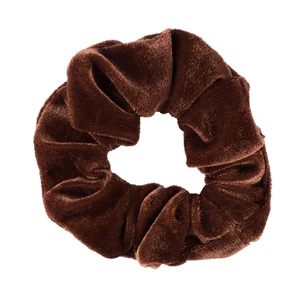 Macro detail of plush dark brown velvet fabric and soft texture on the elastic hair scrunchie