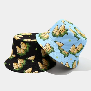 Detail view of double-sided reversible bucket hat featuring cartoon corn patterns