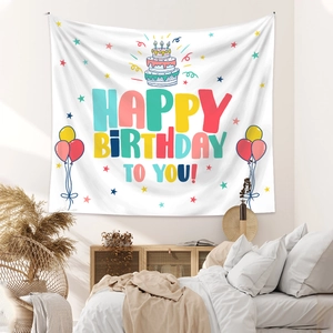 Detail of bohemian Happy Birthday tapestry with colorful cake and balloon wall decor