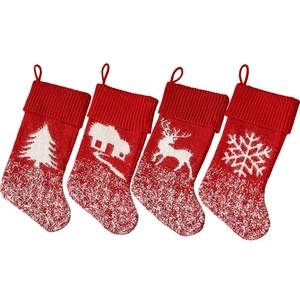 Set of four red knitted Christmas stockings with festive white patterns and hanging loops