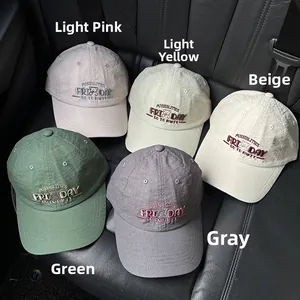Close-up of lightweight cotton baseball caps with bear embroidery in five assorted colors