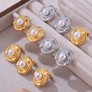 Vintage gold and silver twist metal earrings with inset pearls in a jewelry box