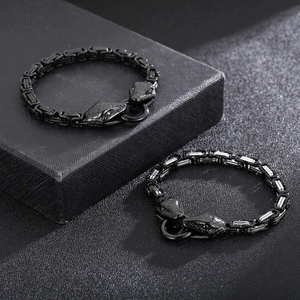 Close-up of Byzantine chain bracelet featuring detailed dual snake head clasps for men