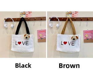 Close-up of white plush tote bags with L-O-V-E embroidery and cute puppy charms