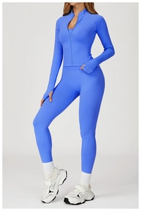 Detail of blue seamless yoga jacket with thumbholes and high-waist sports leggings set