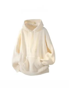 Detail of cream cable knit hoodie featuring a drawstring hood and large front pocket
