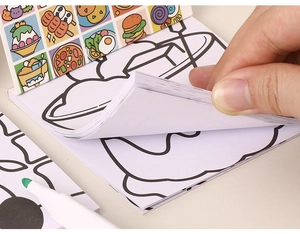 Close-up of children's cartoon coloring book with food illustrations and thick paper