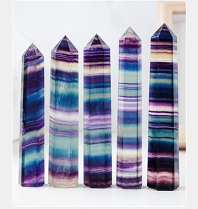 Macro shot of colorful natural rainbow fluorite hexagonal crystal pillars in a row