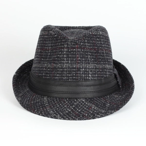 Detail of dark grey plaid fedora hat with black leather band and textured wool finish