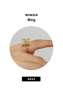 Detail shot of a hollow butterfly ring in 18k gold finish worn by a model