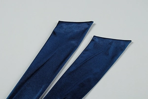 Detailed close-up of dark blue velvet gloves showcasing soft texture and premium stitching