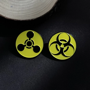 Metal biohazard and radiation warning pins in yellow and black enamel finish