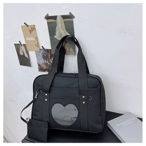 Detail of black JK uniform ita bag with heart-shaped transparent window and coin pouch