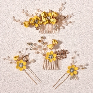 Detailed set of floral hair combs and pins with yellow fabric flowers and gold leaves